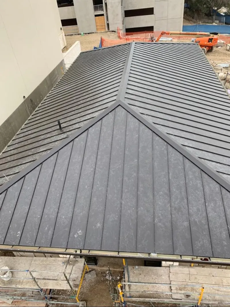 Commercial metal roof construction with crane equipment in Forrest City