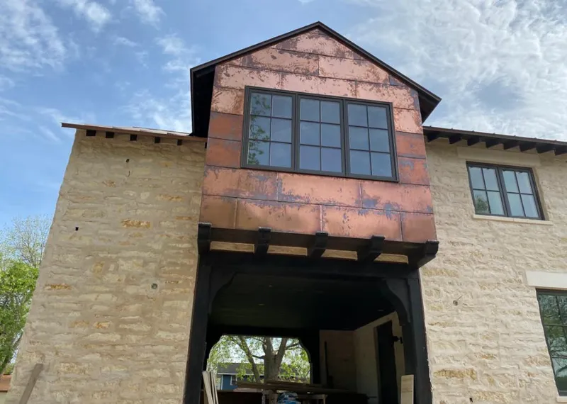 Copper metal panel facade on a stone building for Roof Repair in Forrest City