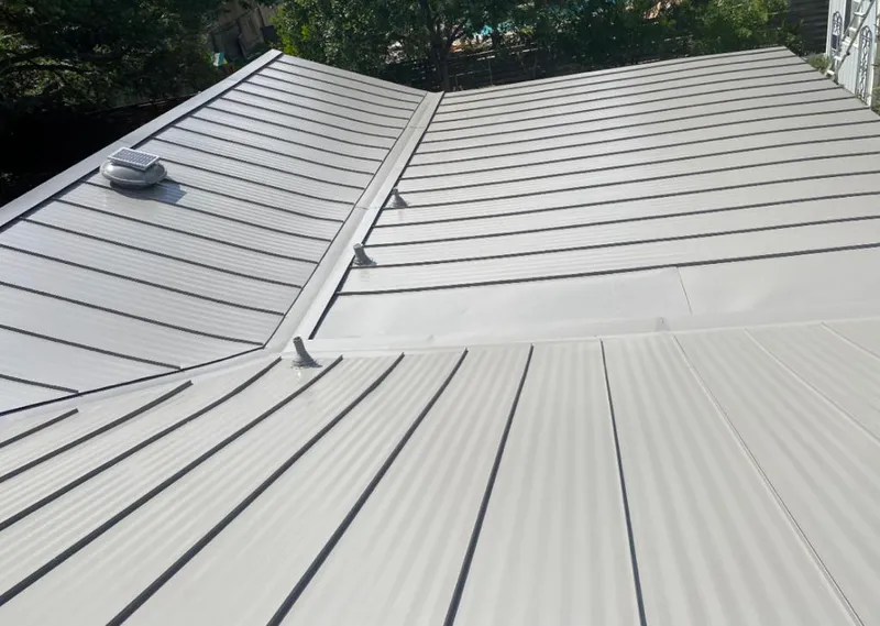 Solar attic fan installed on a metal roof for Roof Ventilation in Forrest City